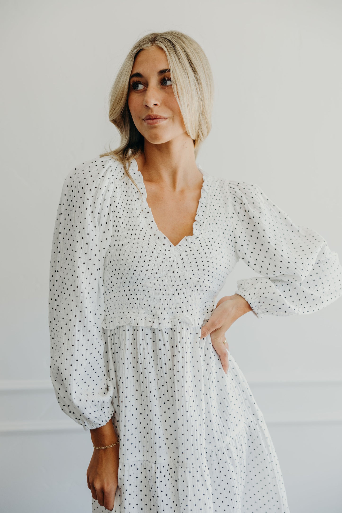 black and white long sleeve polka dot print dress with v neckline.