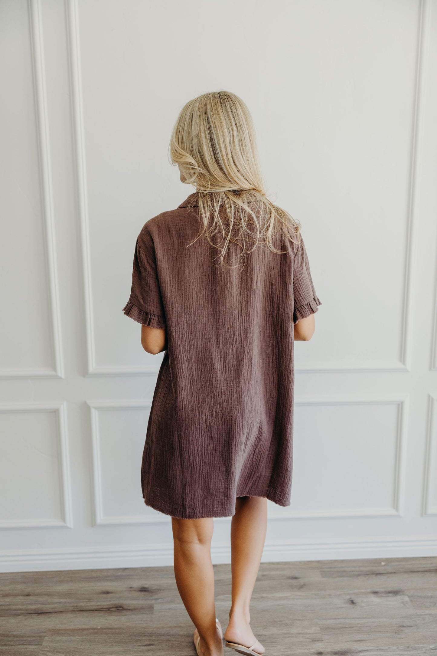 Brown textured dress with ruffle detail on short sleeve.
