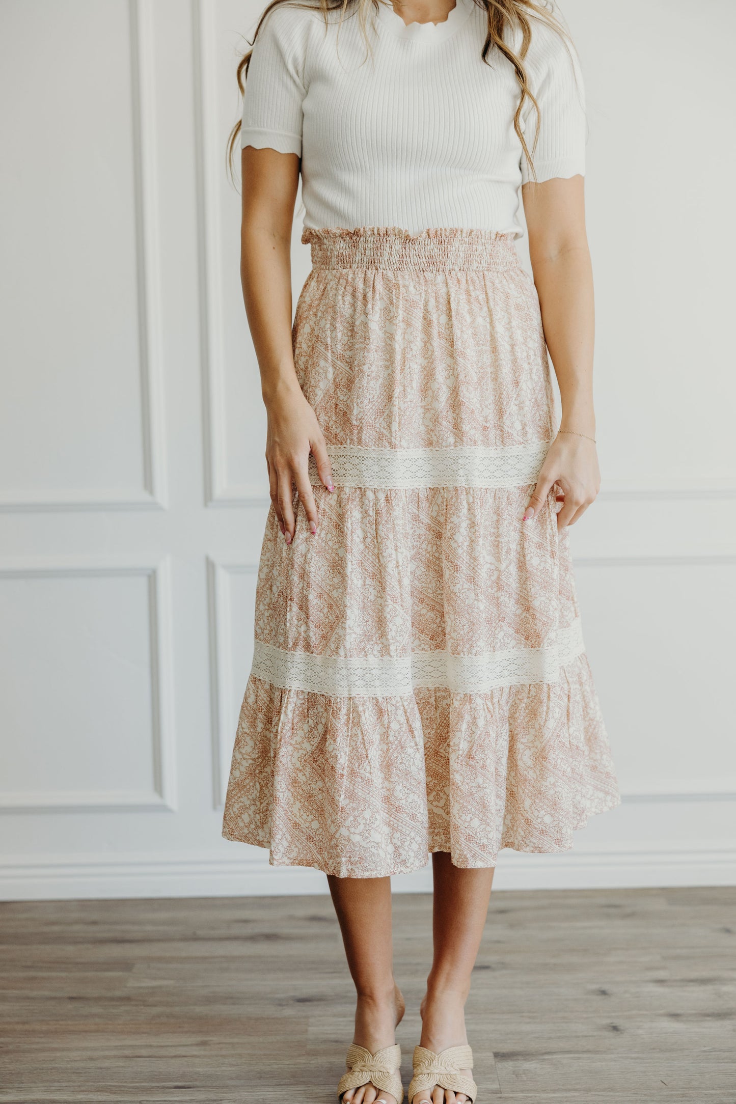 Pink geometric print skirt with lace detail on tiers, and smocked waist.