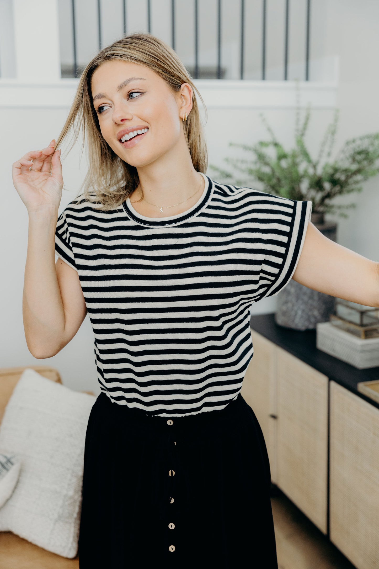 Cream and black striped shirt with round neckline and short sleeves.