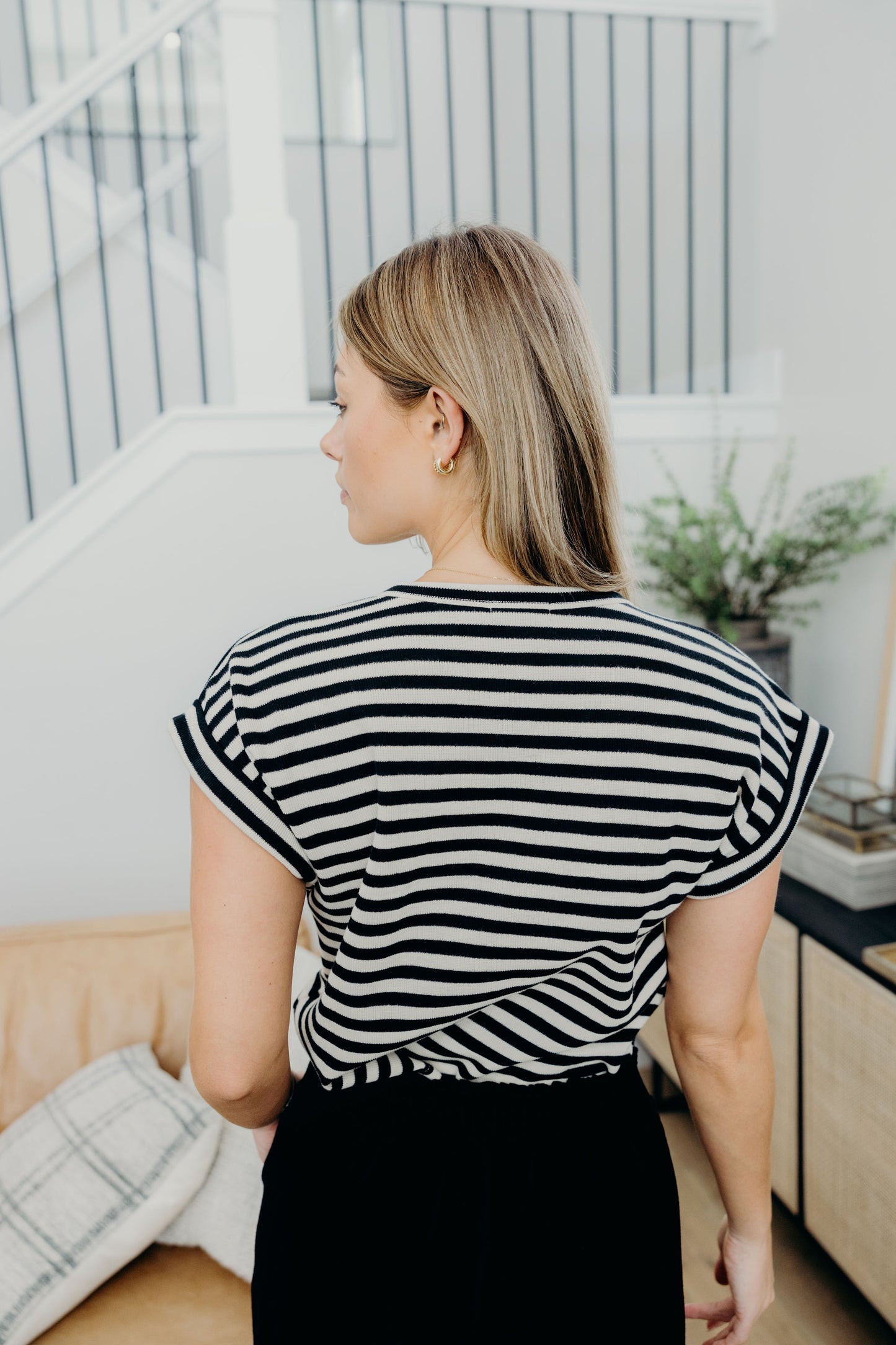 Back view of black and cream striped short sleeve tee.