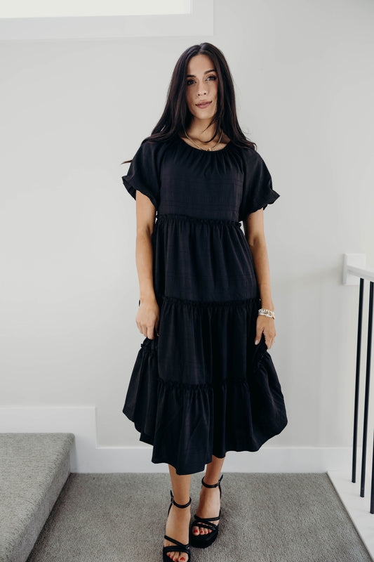 Midi length tiered dress with natural waistline and puff sleeves.
