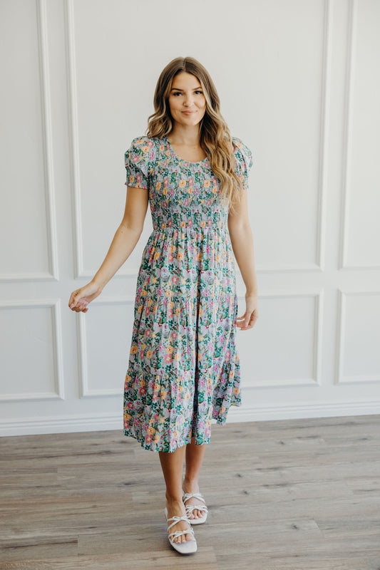 Midi length tiered skirt smocked bodice dress with scoop neckline and short sleeves.