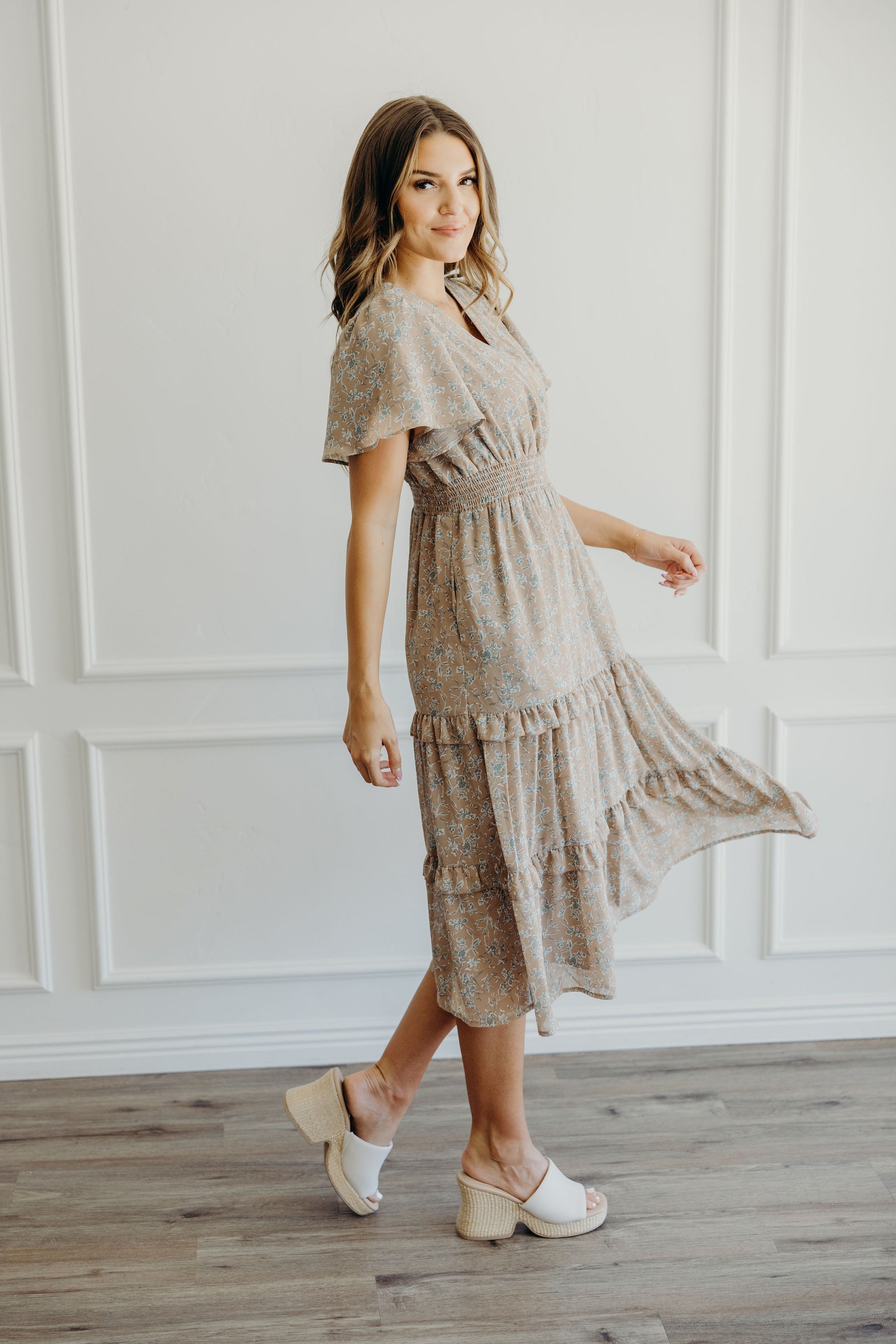 Midi length dress with tiered skirt, smocked waist, v neckline and flutter sleeves.