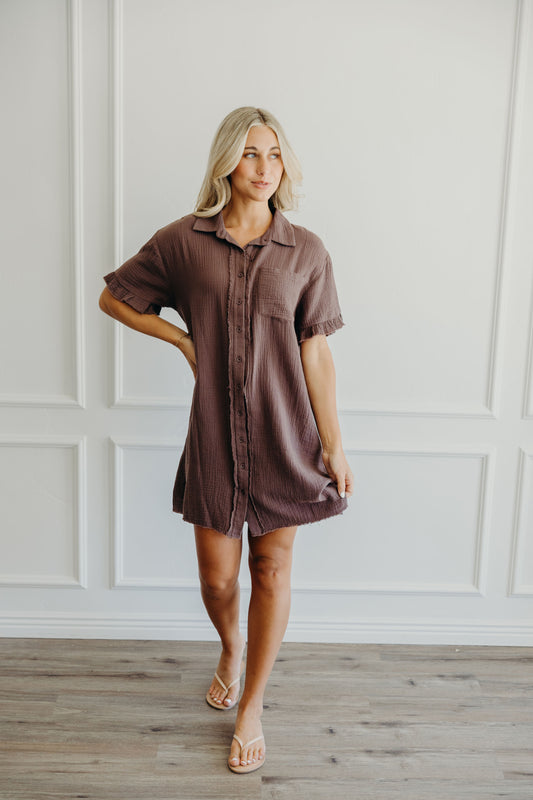 Short brown textured dress with short sleeves, buttons, collar and pocket detail.