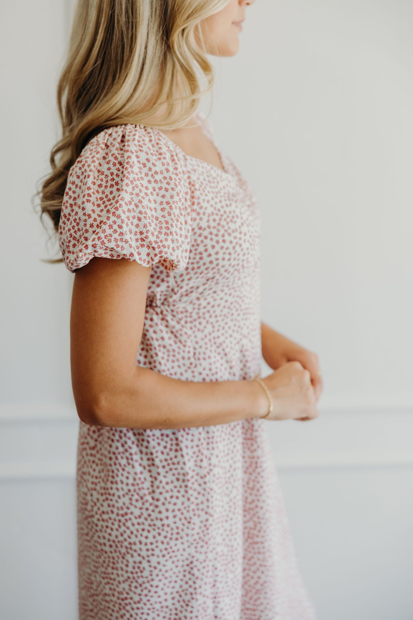 Detail shot of pink floral print and short puff sleeve on shift dress.