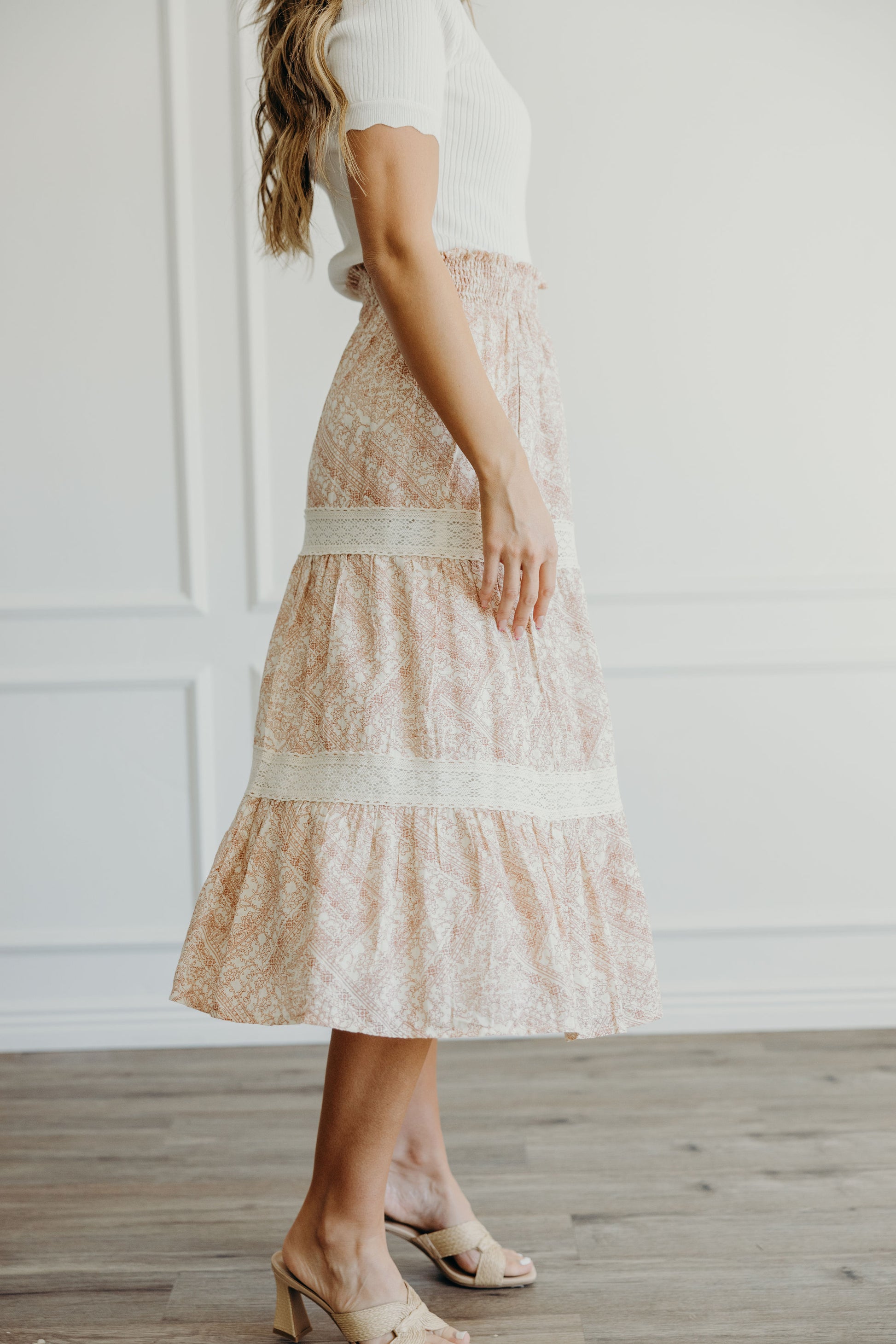 Midi length pink geometric print  tiered skirt with lace detail and ruched waist.