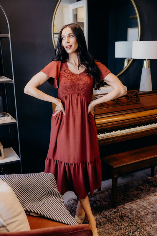 Midi length dress with ruffle hem, smocked bodice with natural waistline, v neckline and flutter sleeves.