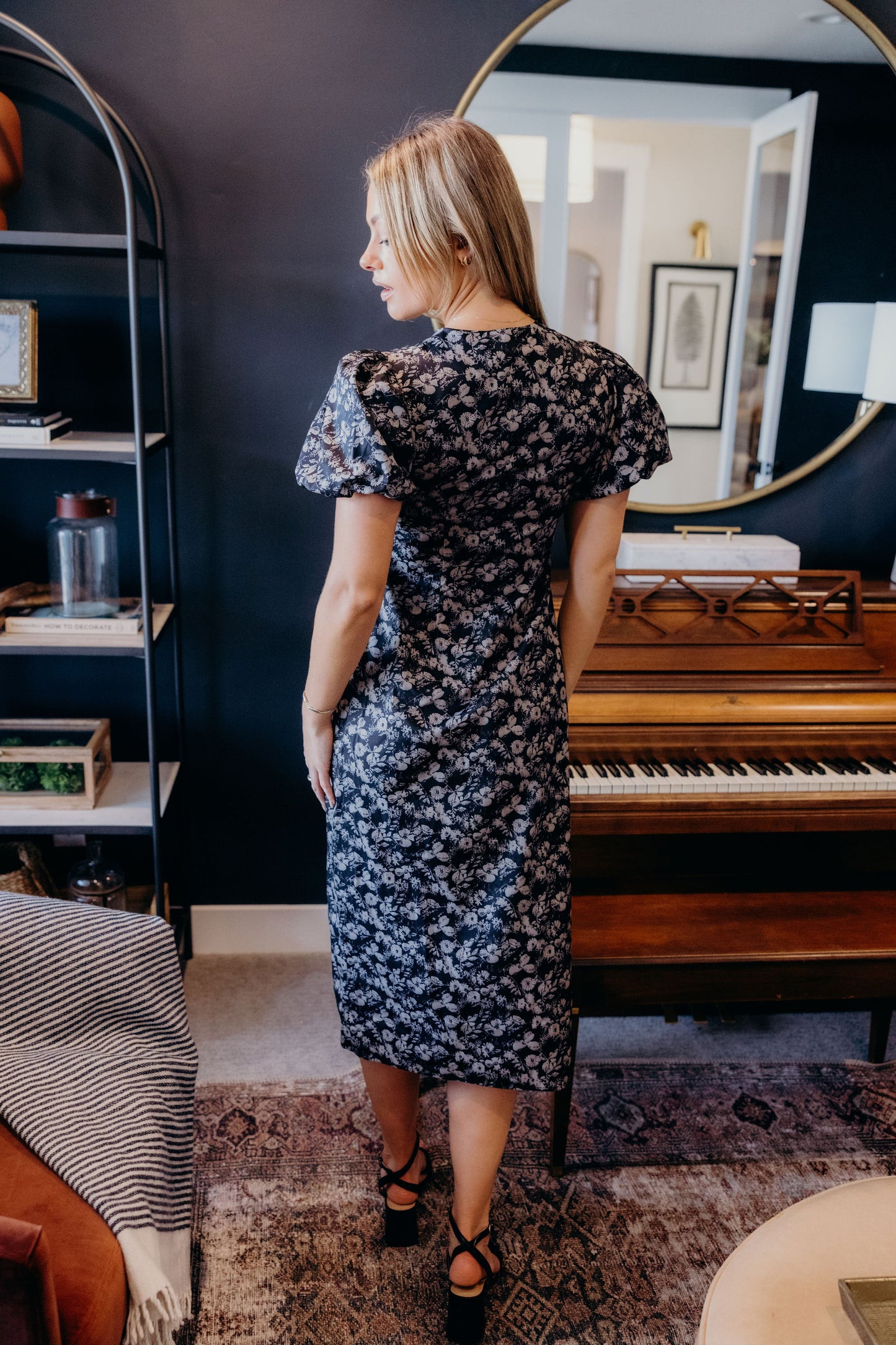 Black floral print fitted dress with short puff sleeves.