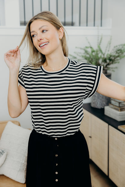 Cream and black striped shirt with round neckline and short sleeves.
