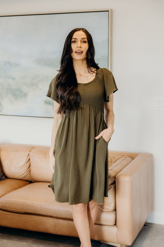 Short dress with smocked bodice with flutter sleeve and pockets.
