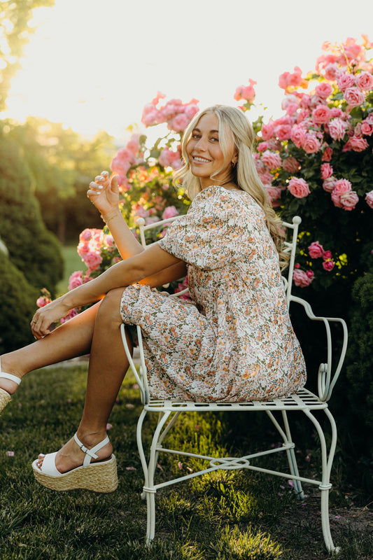 Floral knee length print dress with puff sleeves.